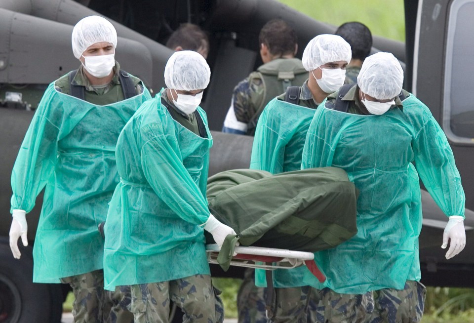 Brazilian soldiers unload the bodies of the crash victims