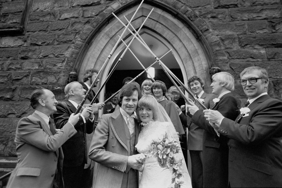 An archway of snooker cues for Alex Higgins and his bride Lynn Avison