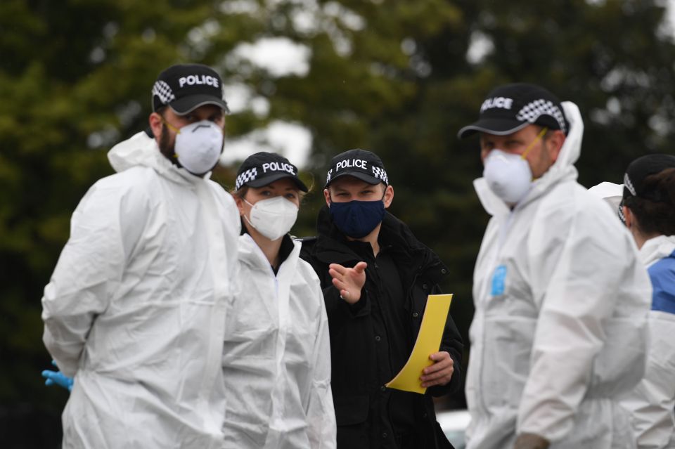 Police officers in forensic suits cordoned off the area in Kesgrave, Suffolk, where the shooting took place