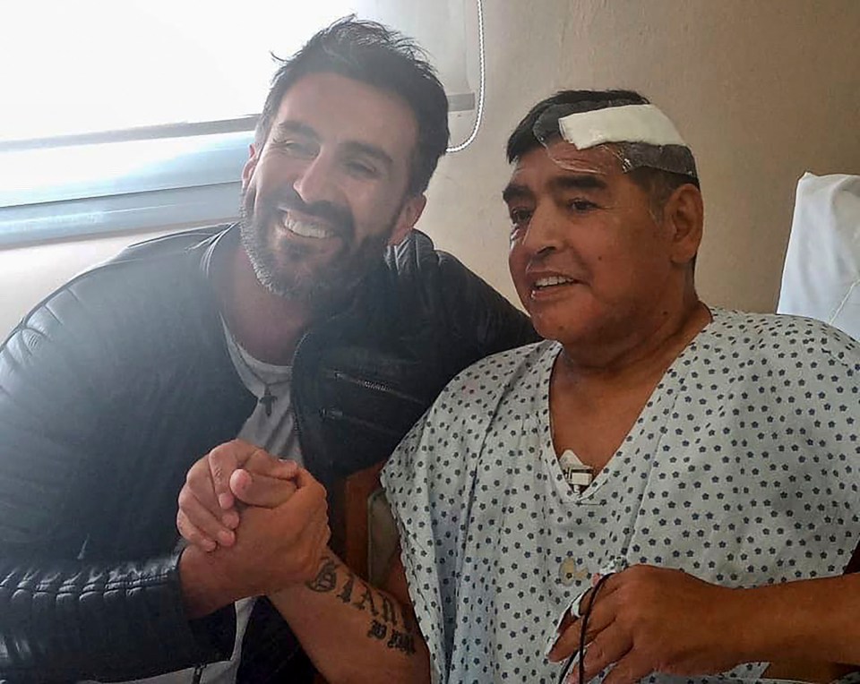 Argentine football legend Diego Maradona shaking hands with his doctor Leopoldo Luque