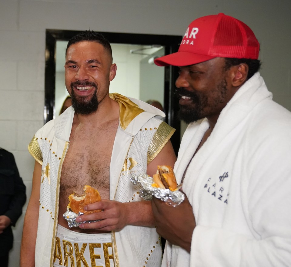 Joseph Parker and Derek Chisora smile backstage