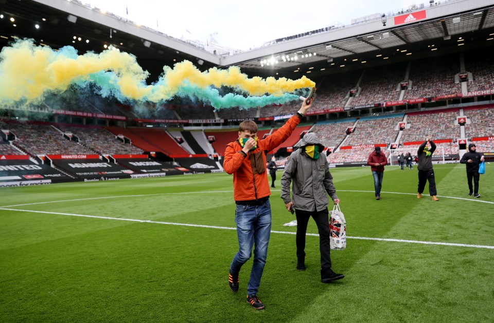 Supporters lit flares after breaking onto the pitch