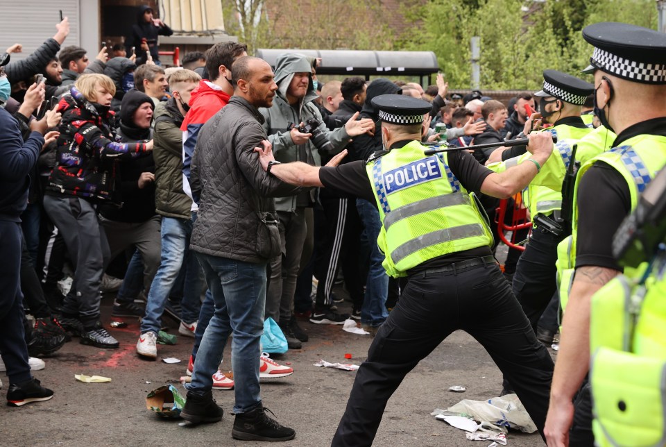 Police with batons attempted to hold back protesters outside the stadium