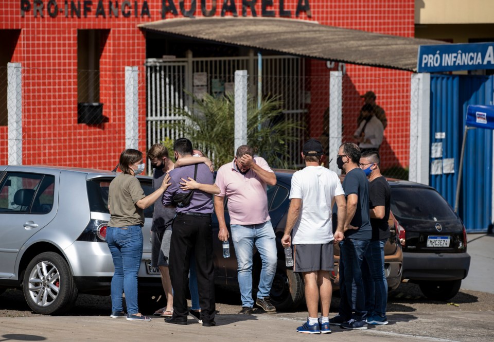 Relatives are comforted outside the daycare centre