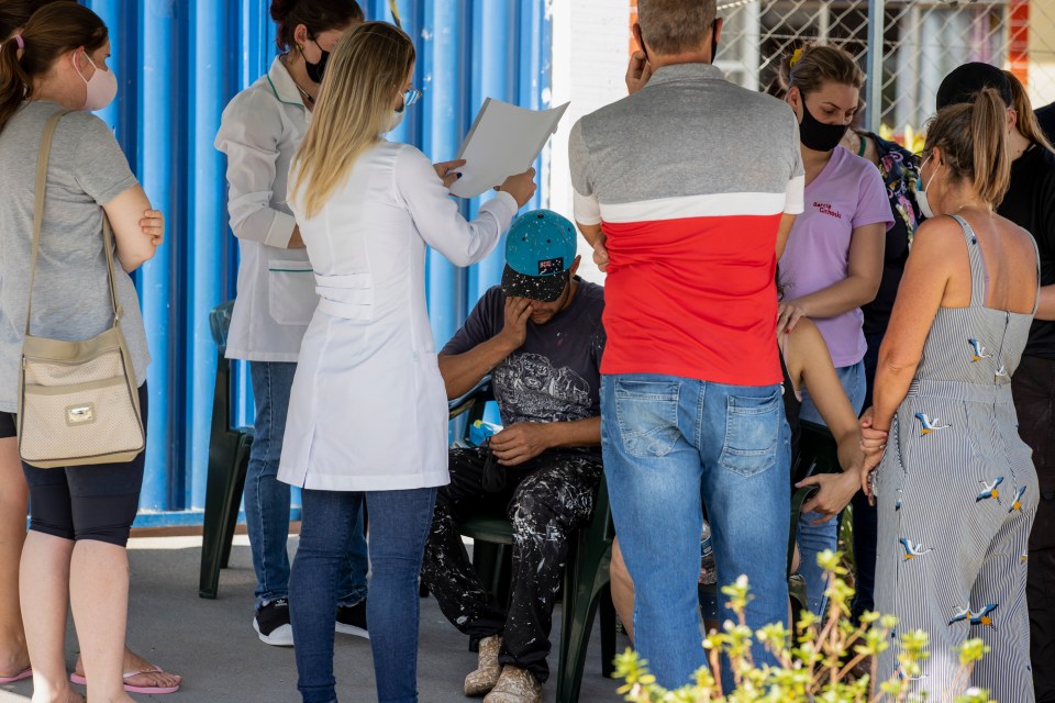 Relatives gather outside the Aquarela preschool in Saudades, in the southern state of Santa Catarina