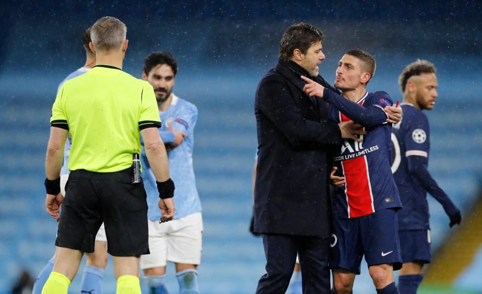 Marco Verratti is held back by PSG manager Mauricio Pochettino