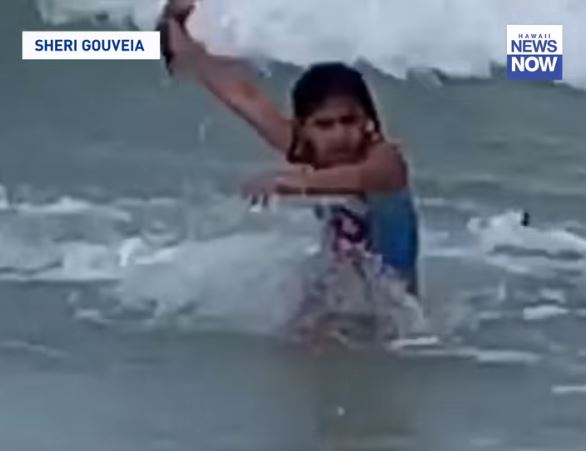 When she realises it's a shark, the 6-year-old then flees the scene in terror