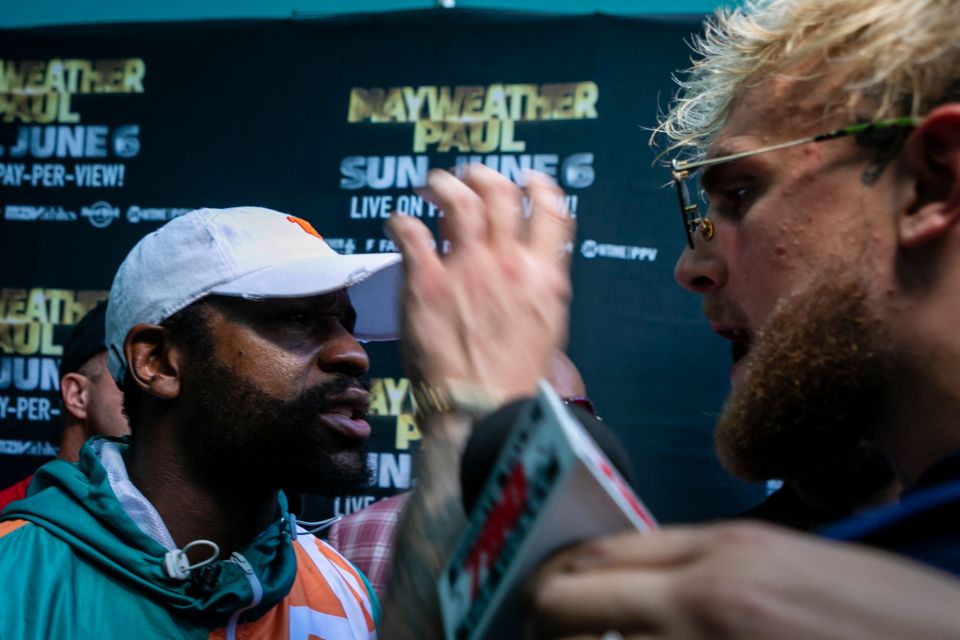 Logan's brother Jake (right) goaded Mayweather by grabbing his hat at the press conference