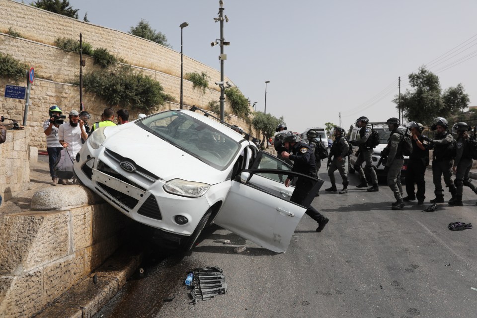 Cops evacuate a driver who crashed his car near the Lions' Gate