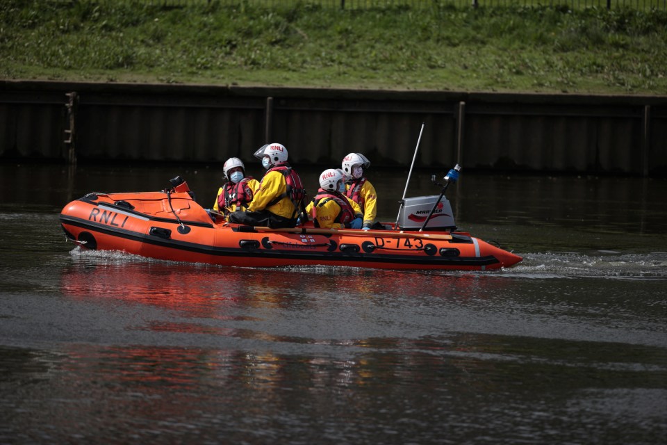 A boat of the Royal National Lifeboat Institution looking for the three-metre minke whale calf