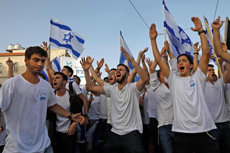 Israelis march with national flags celebrating the Jerusalem liberation day at the Jaffa gate in the old city of Jerusalem