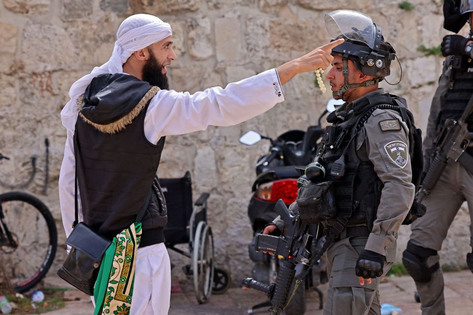 A Palestinian argues with Israeli security forces in Jerusalem's Old City, May 10, 2021, ahead of a march to commemorate Israel's takeover of Jerusalem in the 1967 Six-Day War