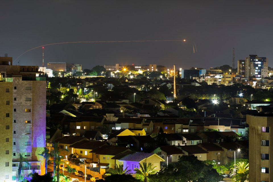 A streak of light is seen as Israel's Iron Dome anti-missile system intercepts a rocket