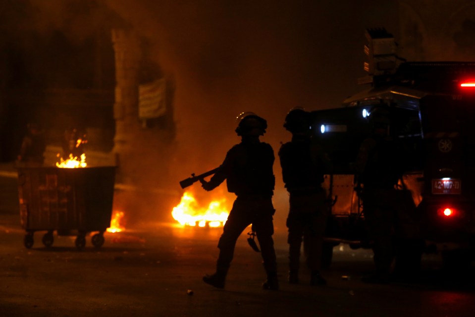 Israeli police take position near burning barricades in Bethlehem