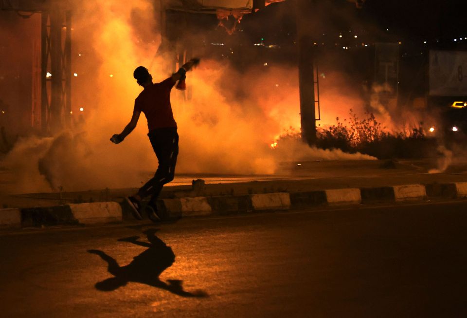 Palestinian protesters burn tyres amid clashes with Israeli troops in the occupied West Bank