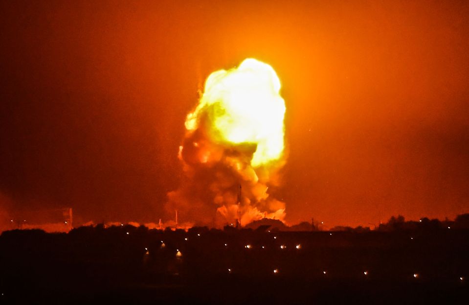 An explosion lights up the sky in Rafah, in the southern Gaza Strip,