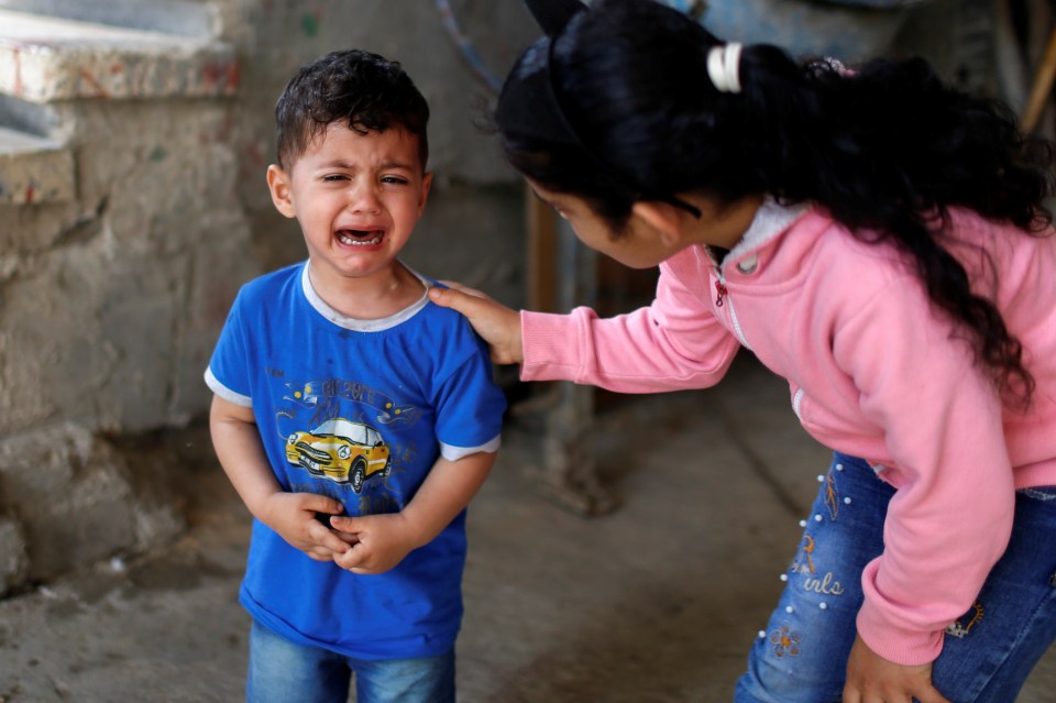 The brother of Palestinian boy Hussien Hamad cries during his funeral