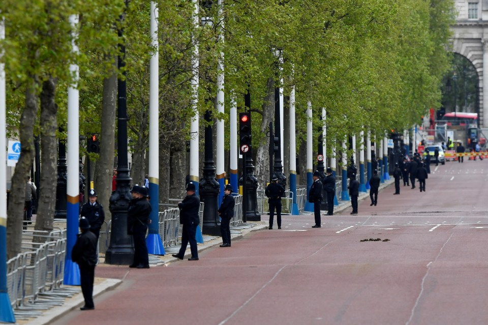 Police officers stand guard along The Mall before the State Opening of Parliament