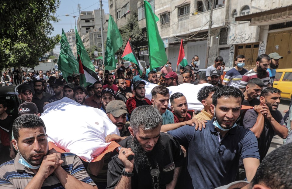 Palestinians mourners carry the bodies of Ameera Soboh and her son, Abed Soboh who were killed in the air strikes