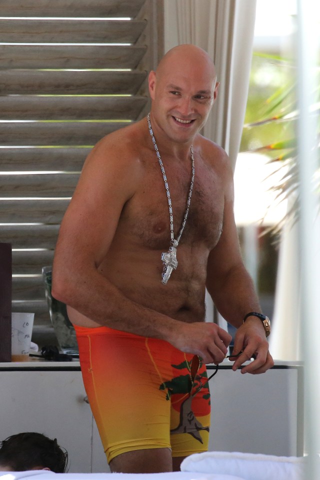 He was wearing his huge diamond cross with his orange swimming trunks