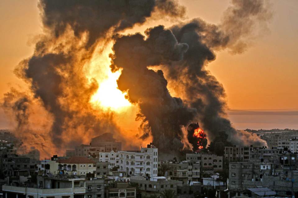 A fire rages at sunrise in Khan Yunish following an Israeli airstrike on targets in the southern Gaza strip