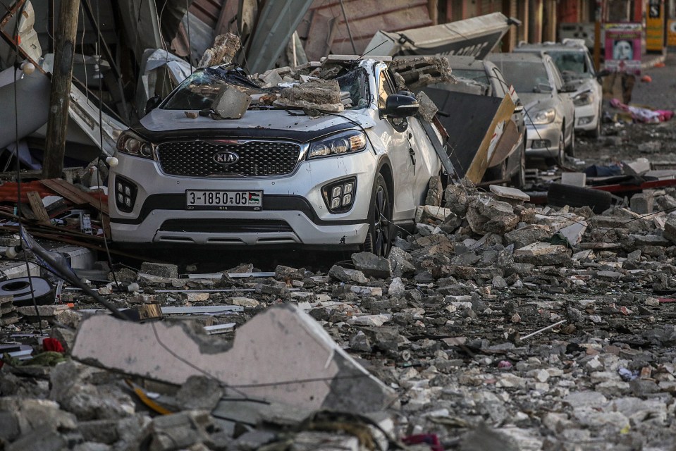 Cars crushed by rubble in the aftermath of overnight Israeli airstrikes on Gaza City