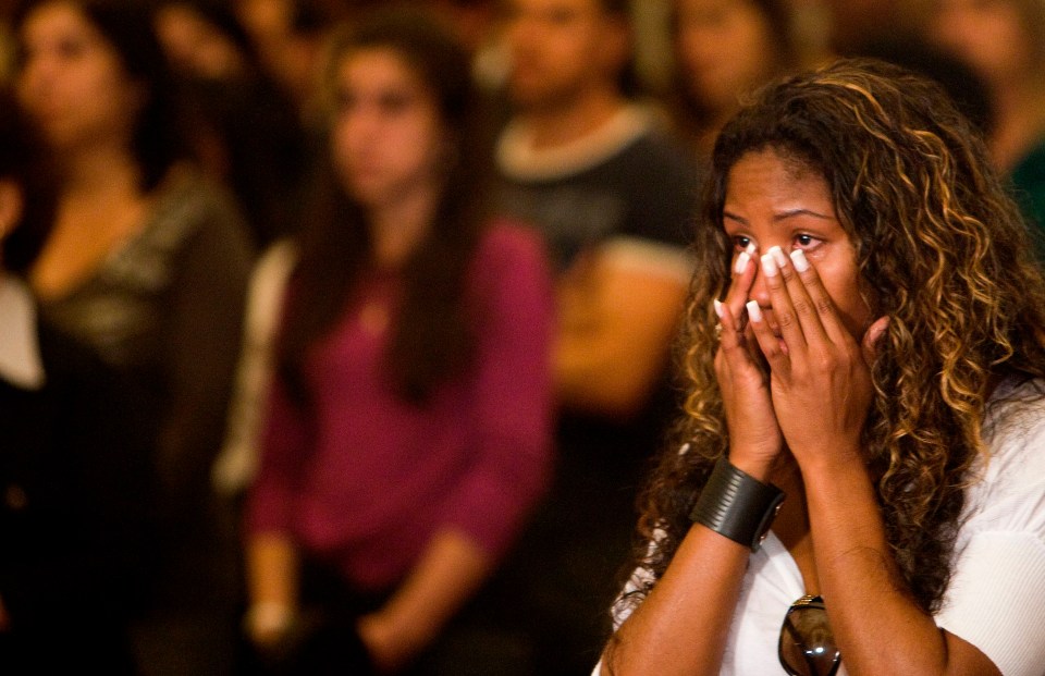 Tuane Rocha, fiancee of one of the victims, cries during a church service