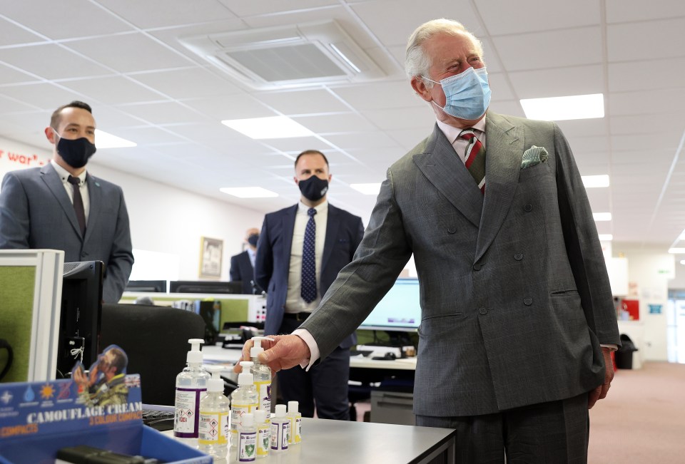 The Prince of Wales looks at hand sanitiser as he visits BCB International