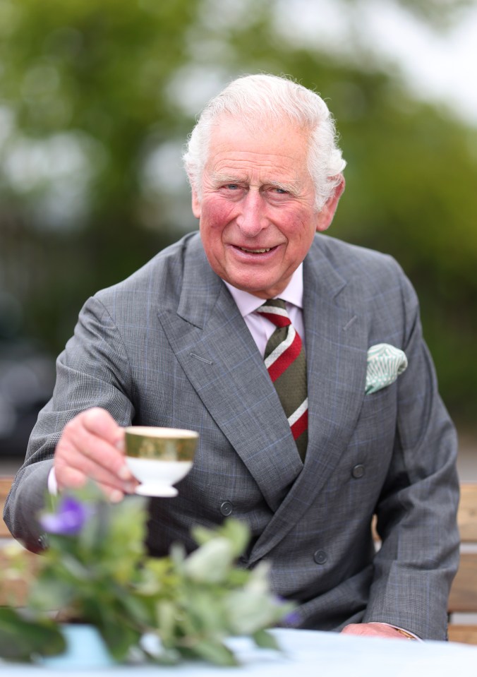 The future king was in good spirits as he enjoyed a refreshment during the tour