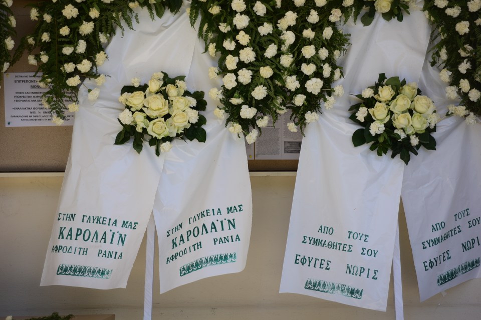 Wreaths reading 'to our sweet Caroline' and 'from your classmates, you've gone too soon'