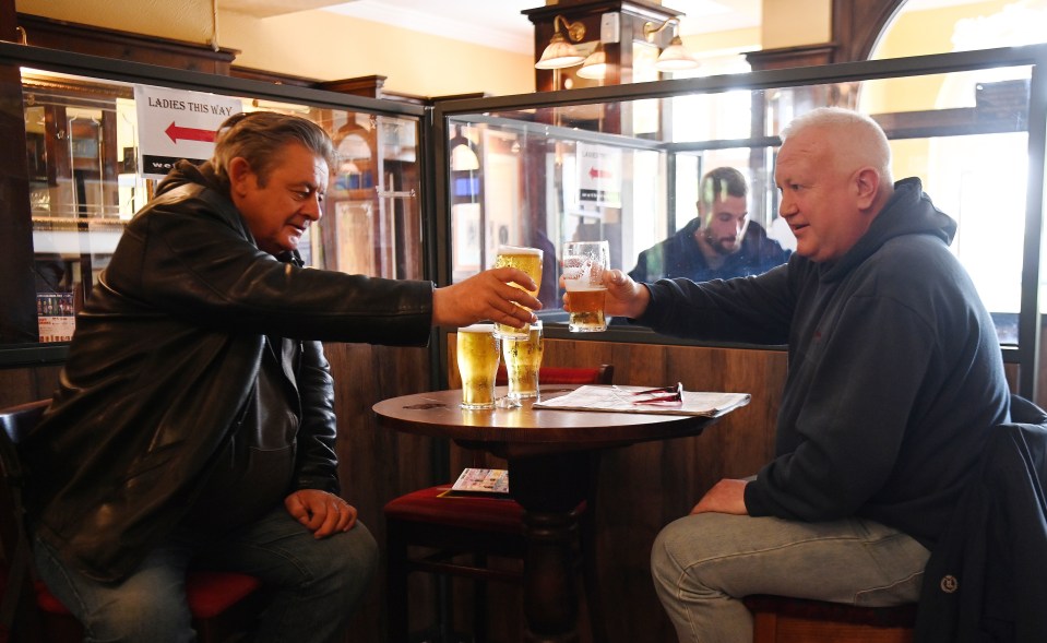 Brits enjoy a pint inside a pub today for the first time in months