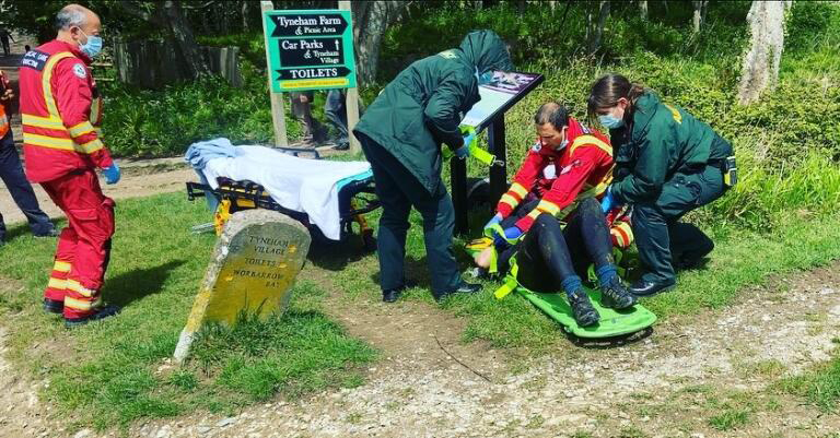 Paramedics tend to the woman victim at the scene of the attack