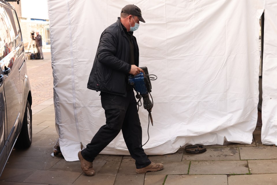 A worker with a power drill at The Clean Plate cafe in Gloucester