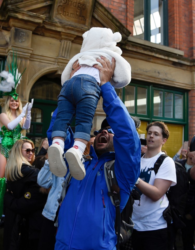 Ryan lifted baby Roman in the air