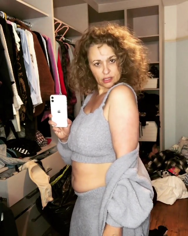 Nadia posed in her messy wardrobe in her grey sweat set