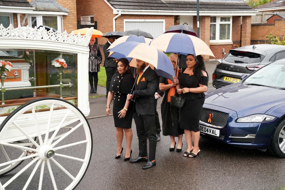 Ashley's mum and sister stood behind the couple on this difficult day