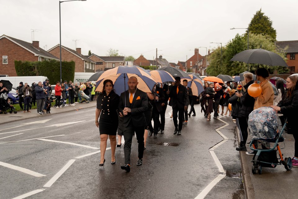 They kept the rain away with personalised umbrellas