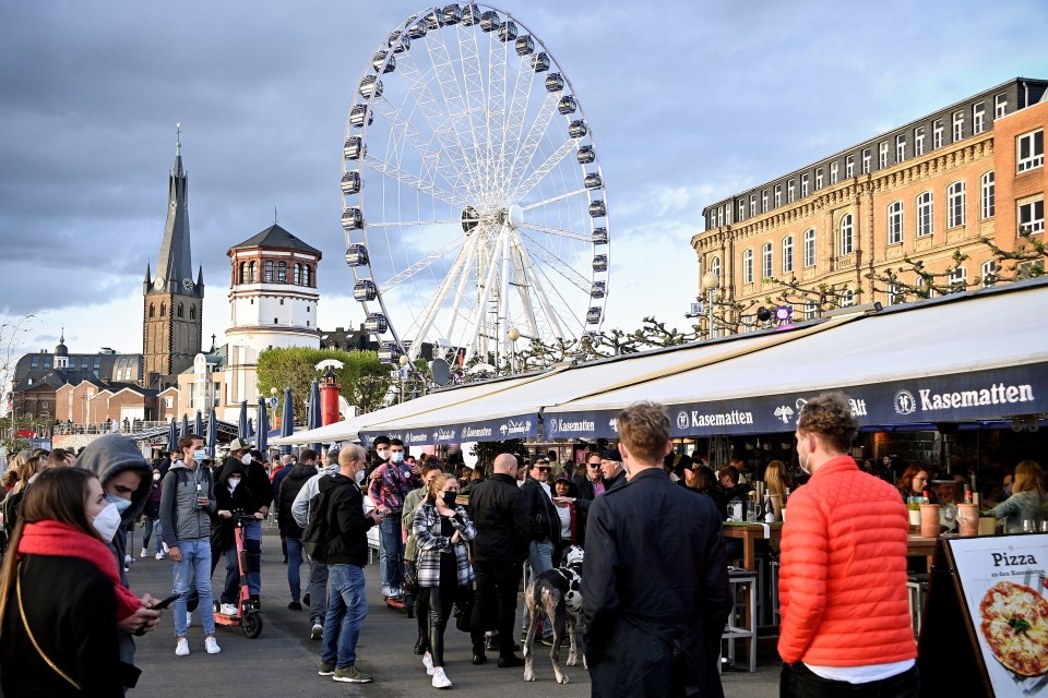 People stroll along the casemates on the banks of the Rhine in Duesseldorf