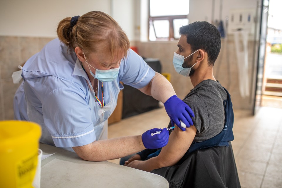 A man receives the Pfizer vaccine at the Masjid E Sajadeen Mosque in Blackburn