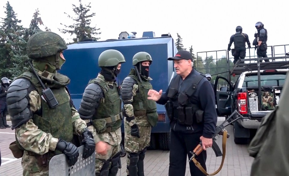 Alexander Lukashenko greets riot police officers on August 23 last year