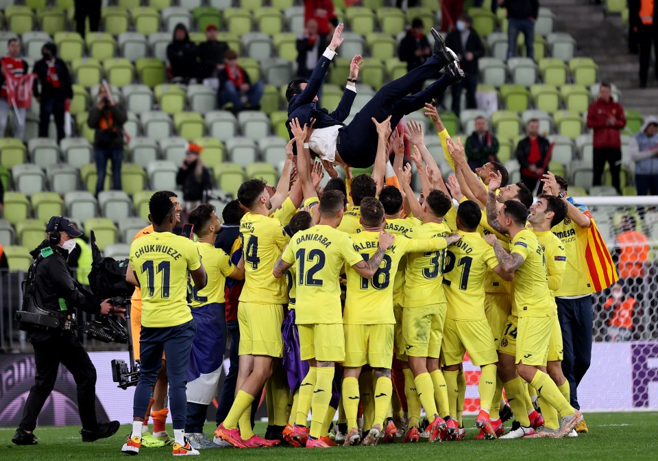 Unai Emery is thrown into the air by his victorious players