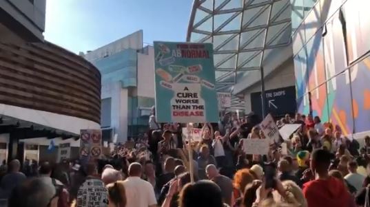 Hundreds of anti-lockdown protestors marched on Westfield shopping centre in West London on Saturday