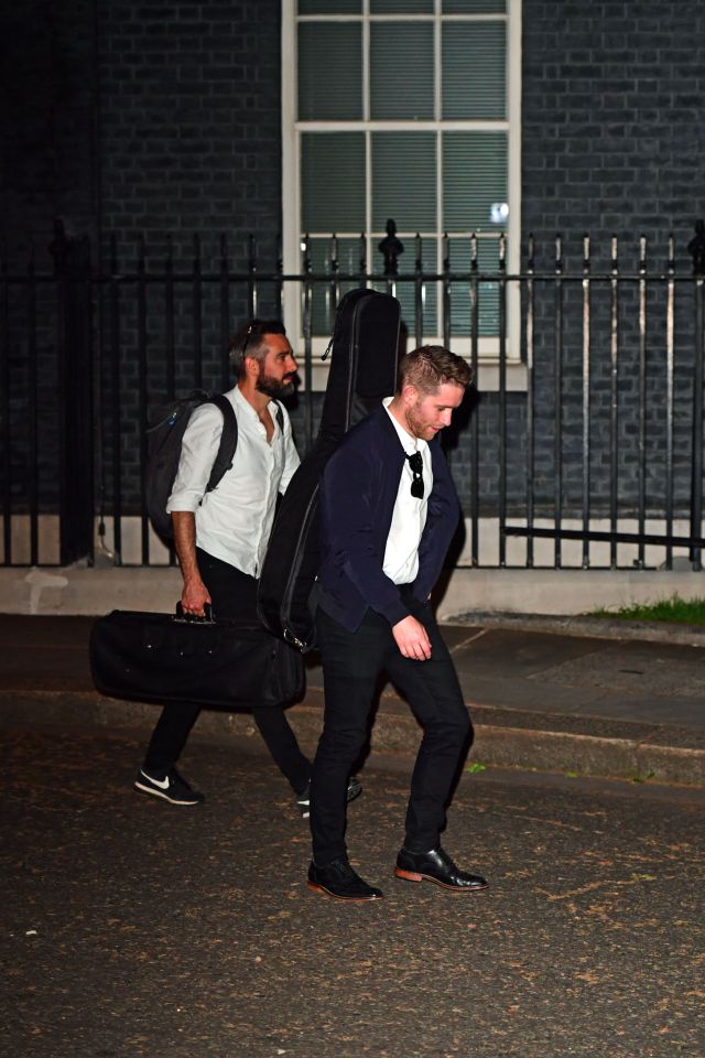 People carrying musical instruments leave 10 Downing Street