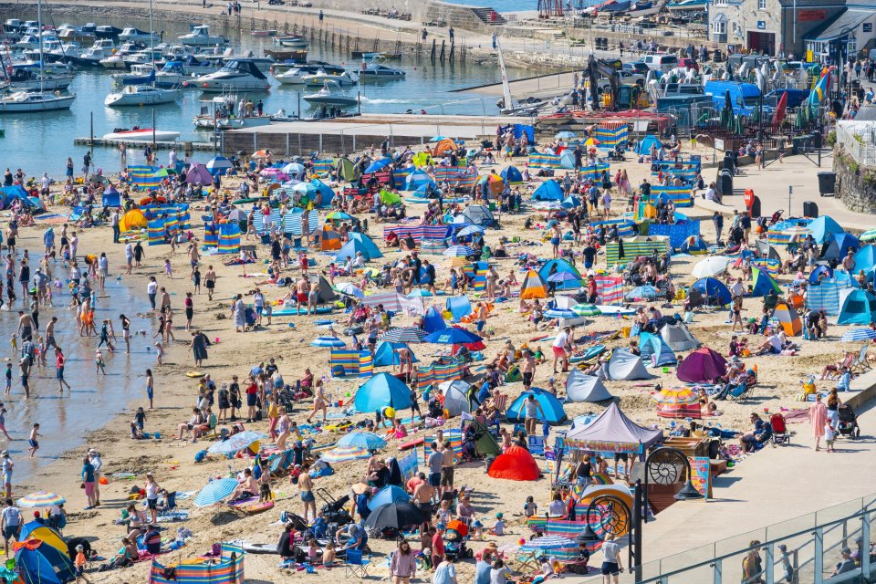 Lyme Regis in Dorset is packed with sun seekers on the hottest day of the year