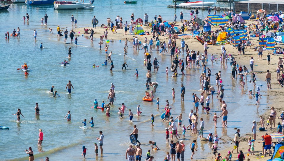 Brits cooled off in the sea as temperatures climbed to the high teens this morning