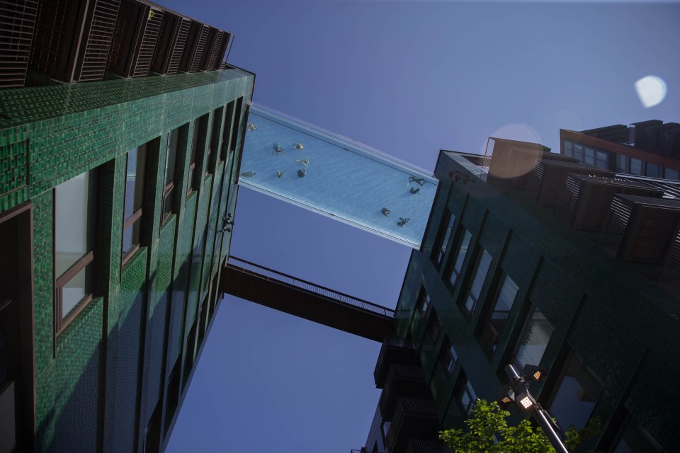 Stunning photographs show swimmers taking a dip in London today - in a pool 115 feet above the ground