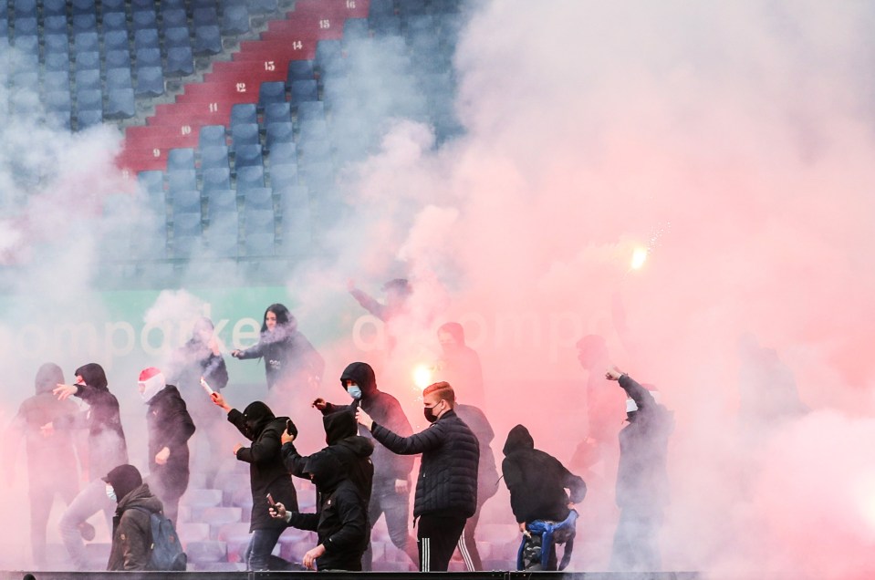 Supporters carrying flares broke into De Kuip