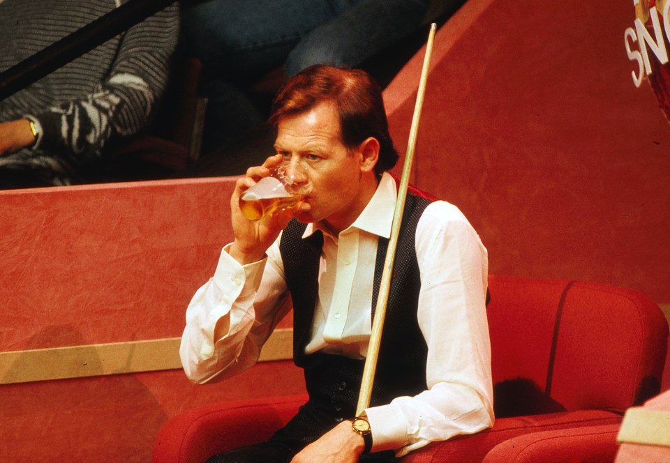 Alex Higgins drinks a pint of beer during his match at the World Championships in 1988