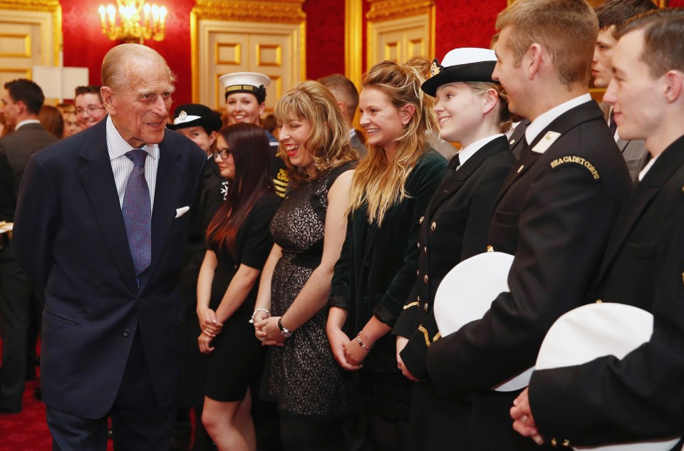 Prince Philip speaks with a group of young people during a reception to celebrate the 500th presentation of his award