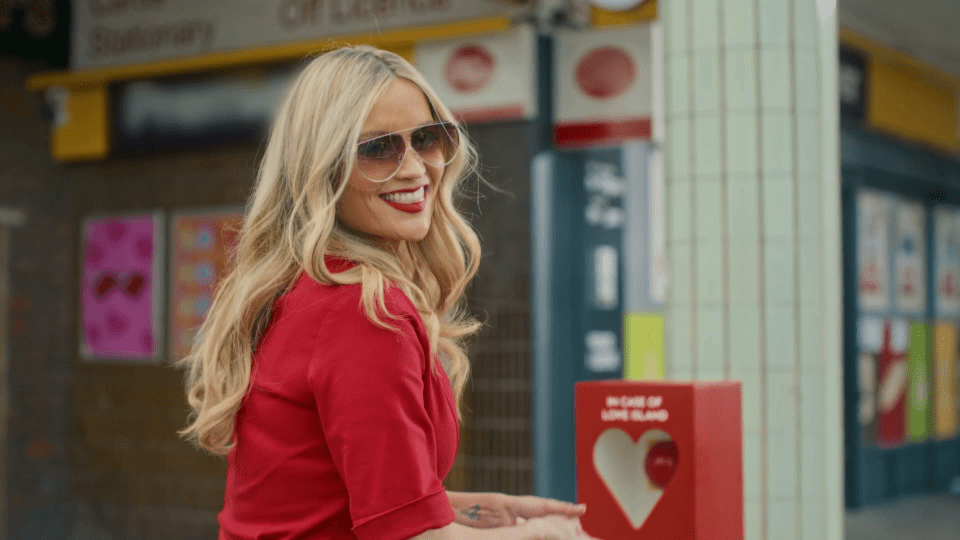 Laura got out and approached a big red box beside a London post office